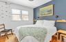 Bedroom with hardwood / wood-style flooring and a baseboard radiator