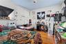 Bedroom with wood finished floors, crown molding, and freestanding refrigerator