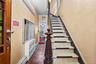 Stairway with crown molding and baseboard heating