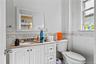 Half bath featuring vanity and tile walls