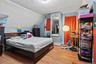Bedroom with lofted ceiling and wood finished floors