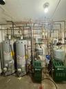 Utility room featuring water heater and a heating unit
