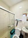 Full bathroom featuring a shower stall, tile walls, and tasteful backsplash