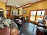 Living room with ornamental molding, recessed lighting, and granite floors