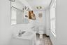 Half bath featuring light tile patterned floors and vanity