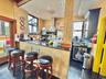 Kitchen featuring wall chimney exhaust hood, granite tiled floors, tile walls, recessed lighting, and stainless steel fridge