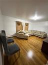 Living area featuring light wood finished floors and baseboard heating