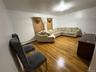Living room featuring wood finished floors and a baseboard heating unit