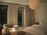 Guest ensuite bedroom w/ floor to ceiling windows and Luxury European Light Fixture