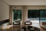 Living room with floor to ceiling marvin windows view to the backyard