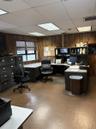 Home office featuring wooden walls, a paneled ceiling, and light flooring