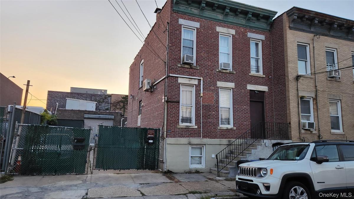 Italianate house with brick siding and a gate