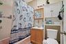 Bathroom with shower / bath combo with shower curtain, toilet, and vanity