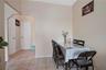 Dining area with baseboards, light tile patterned flooring, and arched walkways