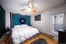 Bedroom featuring baseboard heating, hardwood / wood-style flooring, and ceiling fan