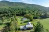 View from above of property with a forest and a mountainous background