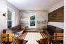 Living area with wood finished floors and a baseboard heating unit
