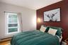 Bedroom featuring a baseboard radiator and wood finished floors