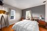 Bedroom featuring crown molding and light wood-type flooring