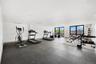 Workout area with baseboards and expansive windows