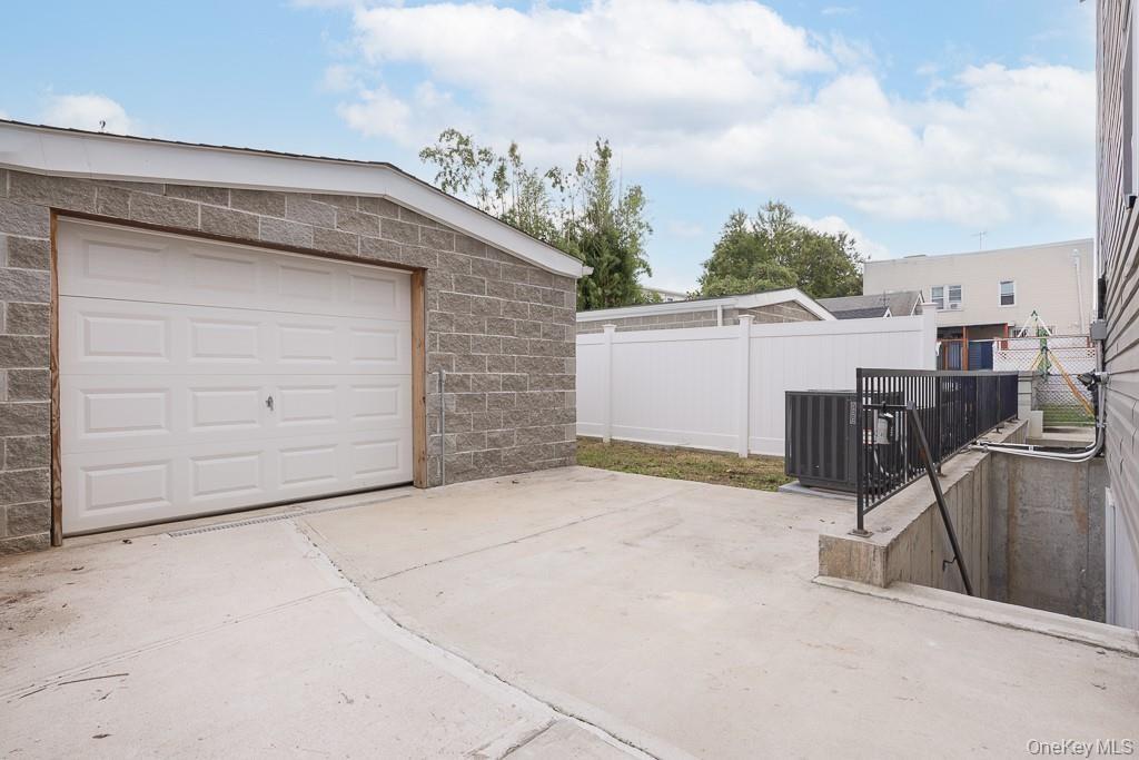 Garage featuring concrete driveway