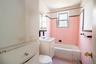Full bathroom with vanity, toilet, tiled shower / bath, and tile walls