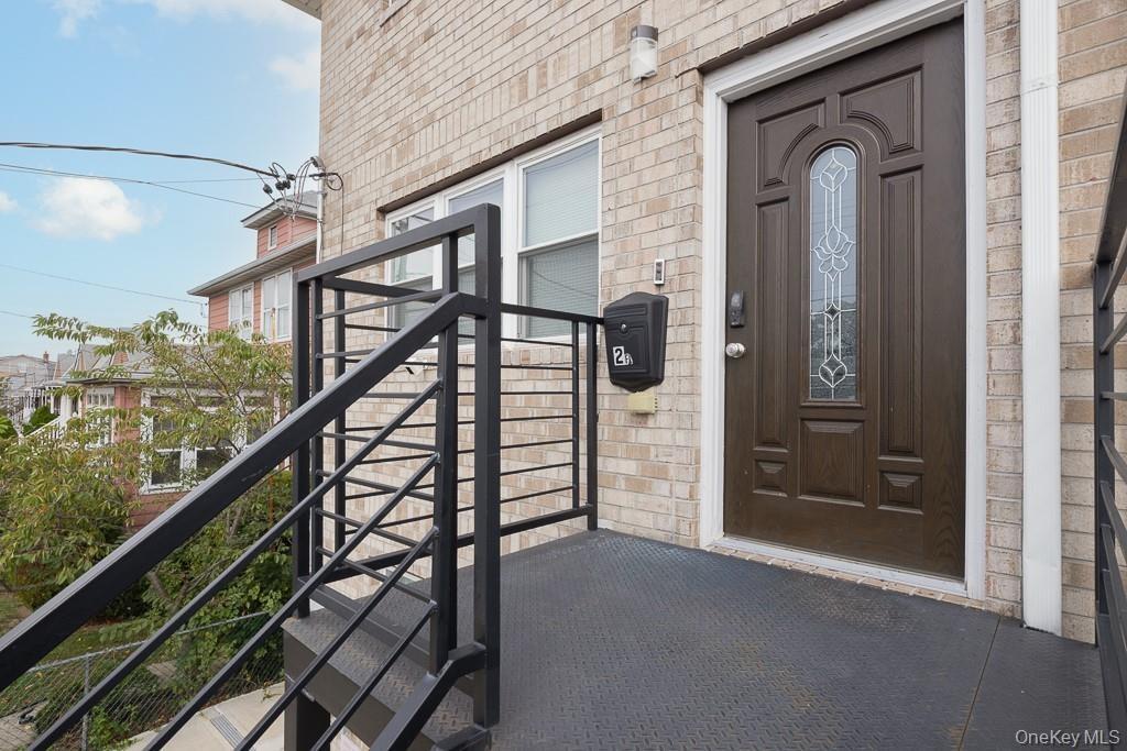 Property entrance featuring brick siding