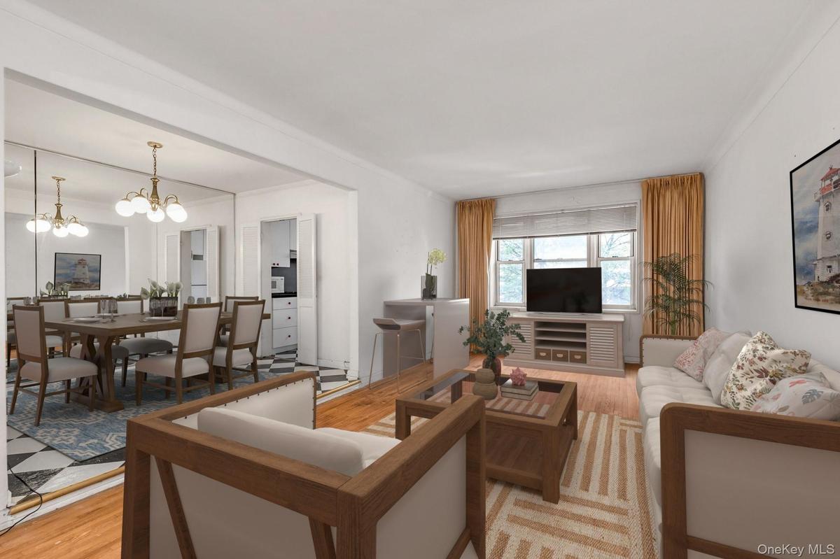 Living area featuring light wood-style flooring, a chandelier, and crown molding  - Virtually Staged