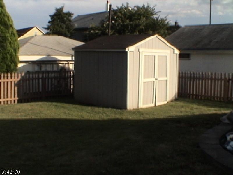 Fenced in back yard with shed