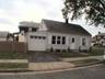 Front of home, fenced in yard.