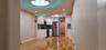 Kitchen featuring backsplash, white cabinetry, appliances with stainless steel finishes, light wood-style floors, and light countertops