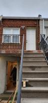 Doorway to property with brick siding