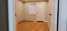 Doorway with wood finished floors, a baseboard heating unit, and recessed lighting