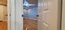 Corridor with wood finished floors and recessed lighting