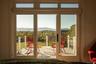 Doorway with a mountain view and view of wooded area