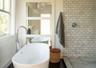 Full bathroom with healthy amount of natural light, a shower stall, and a freestanding bath