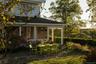 Back of house with a sunroom and a shingled roof