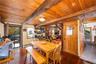 Dining area featuring hardwood / wood-style floors, baseboard heating, and a wooden ceiling with exposed beams