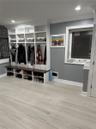 Mudroom featuring crown molding and light hardwood / wood-style flooring
