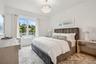 Bedroom featuring light wood-type flooring and an inviting chandelier