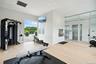 Exercise area with elevator and light hardwood / wood-style floors
