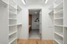 Spacious closet with light hardwood / wood-style flooring