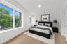 Bedroom featuring vaulted ceiling and light wood-style floors