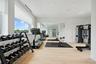 Workout area with light hardwood / wood-style floors