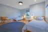 Third bedroom with linen wallpaper and custom lighting