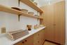 Pantry oak cabinetry and storage closet