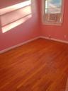Unfurnished room with light wood finished floors and cooling unit