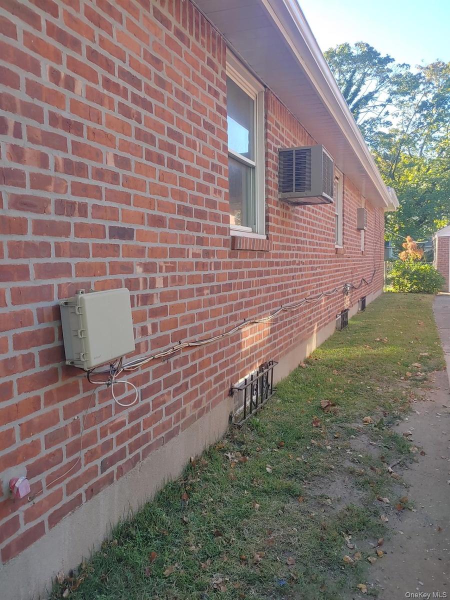 View of side of home with brick siding