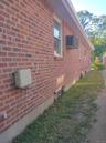 View of side of home with brick siding