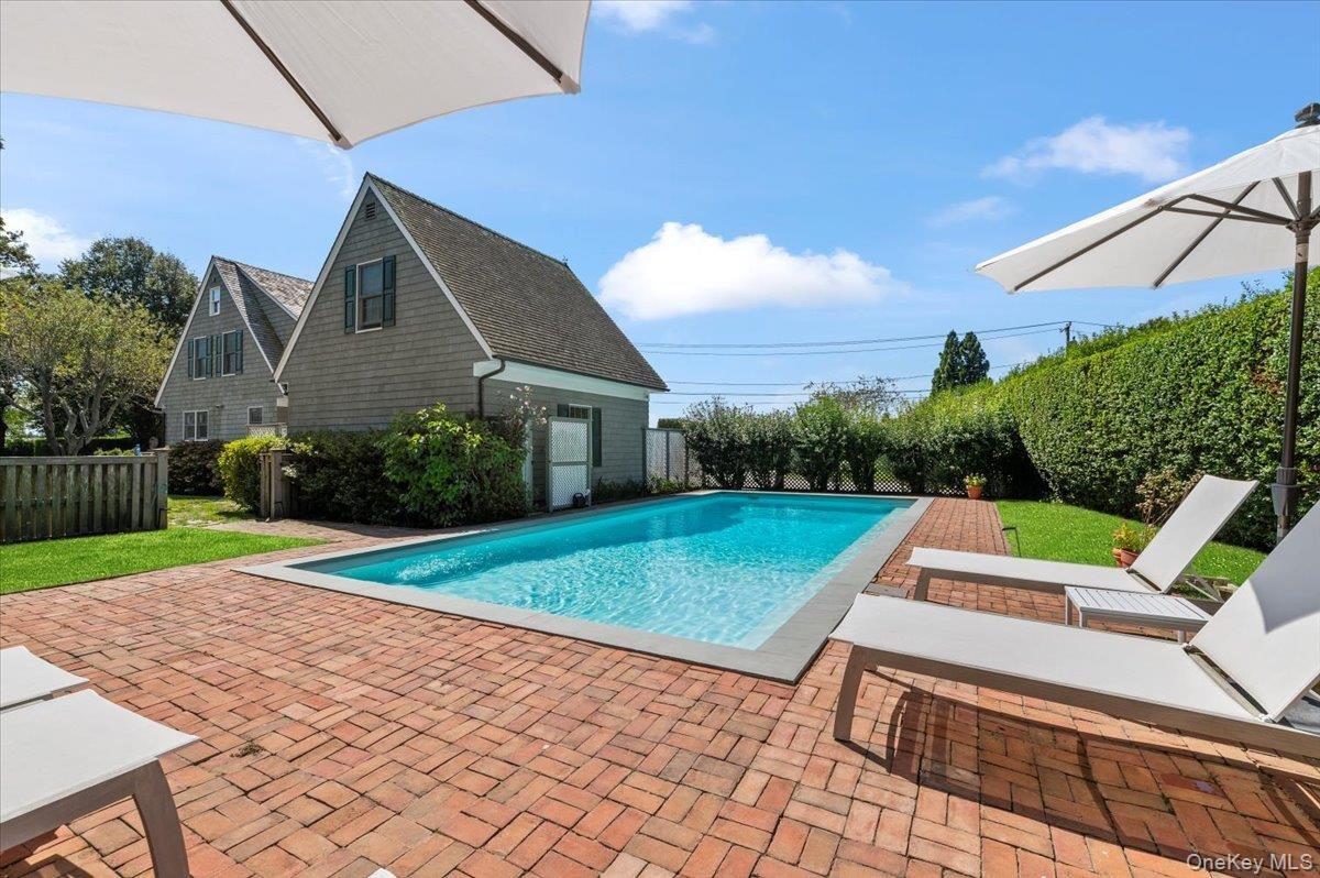View of swimming pool featuring a fenced backyard and a patio